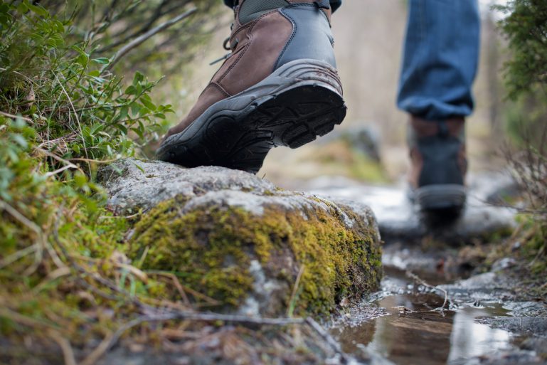 Une personne marche dans la nature avec des chaussures de rando