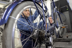 Homme testant en laboratoire un vélo à assistance électrique