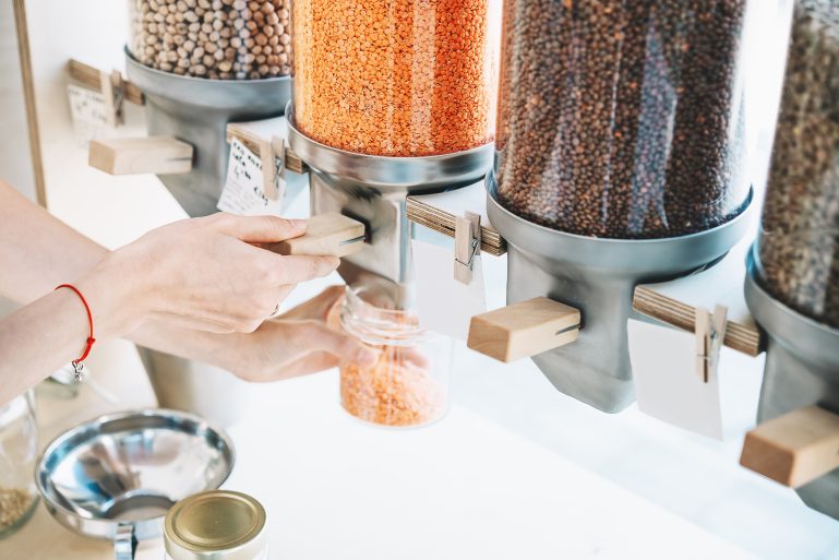 Une femme remplit un pot avec des lentilles corail