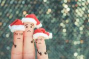 Une famille triste dessinée sur des doigts avec des bonnets de Père Noël