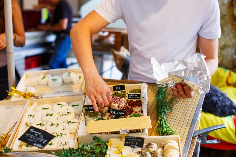 Vendeur attrapant un fromage à emballer