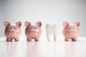 Des tirelires cochons encadrent une dent.