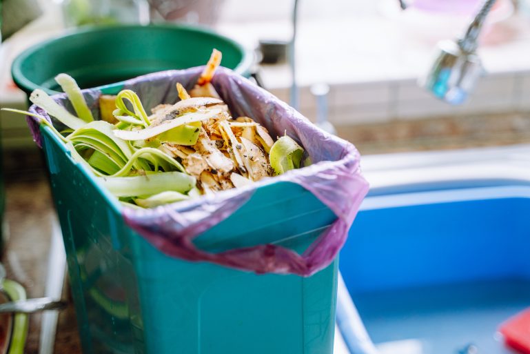 Une mini poubelle de compostage pleine dans une cuisine