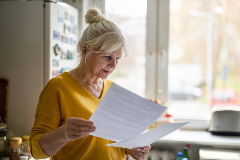 femme âgée examinant des papiers administratifs