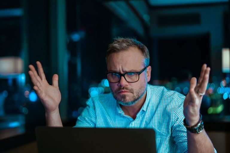 Homme frustré devant son ordinateur