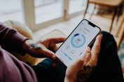 Un homme contrôle la température de son logement avec son mobile