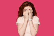 Une femme se cache le visage avec ses mains