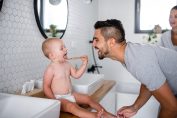 Un papa et son bébé qui se brosse les dents