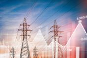 Des poteaux électriques sur fond de courbe du marché de gros de l'électricité